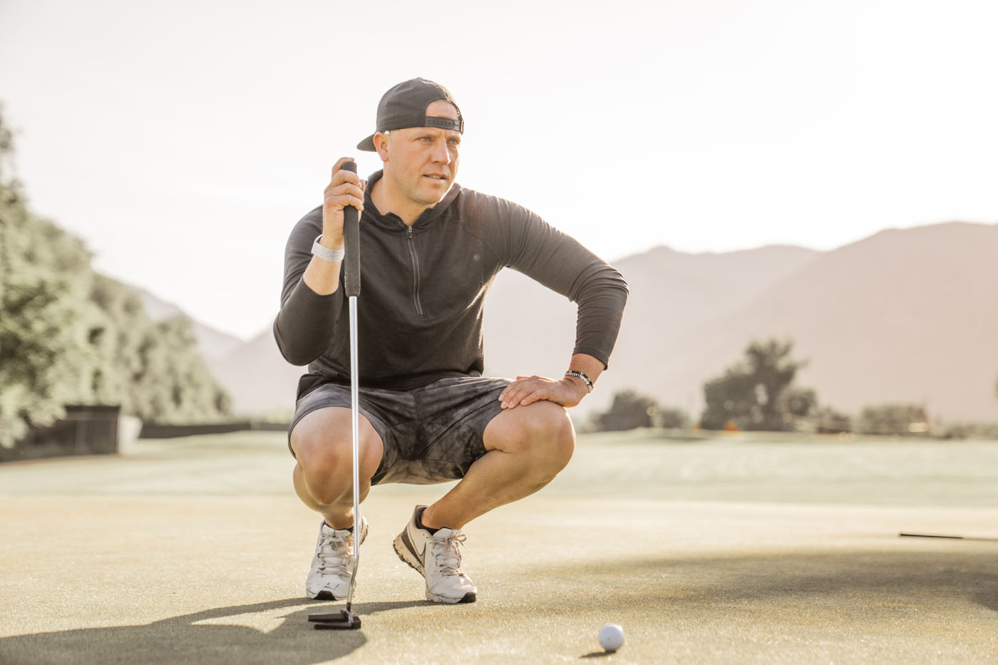 A golfer on the field working on overcoming his performance plateau - learn more about how to improve your game using data and coaching from Tee Box!